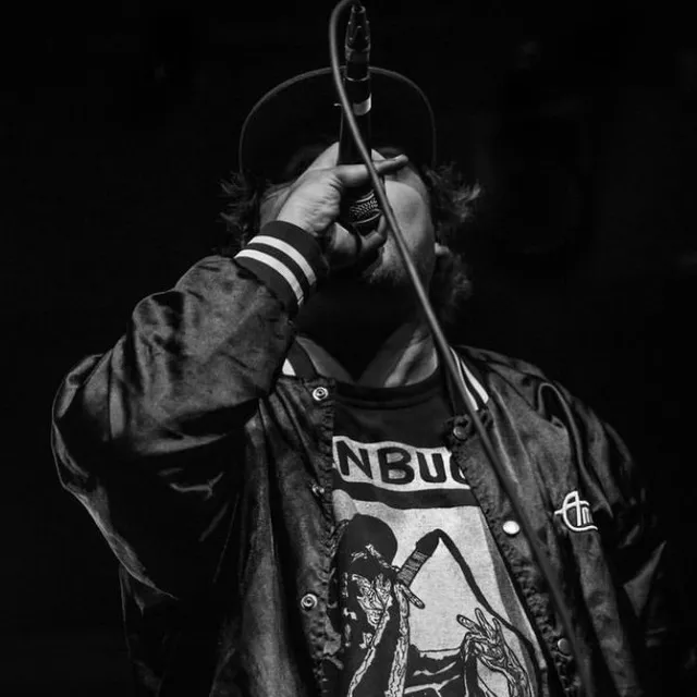 Ben Buck on the mic, in black and white